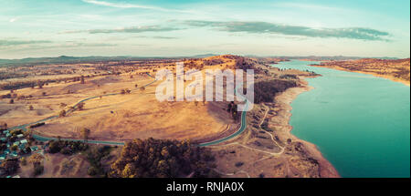 Panoramica aerea di Riverina autostrada passando vicino al lago di Hume e il fiume Murray al tramonto. Nuovo Galles del Sud, Australia Foto Stock