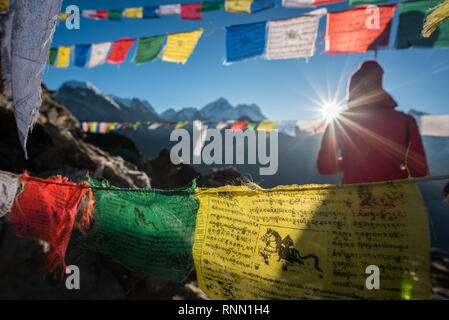 Un escursionista solitario testimoni un incredibile sunrise dal Gokyo Ri vertice. Foto Stock