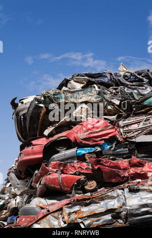 Impilati e schiacciata di automobili a un metallo di scarto riciclaggio junkyard Foto Stock