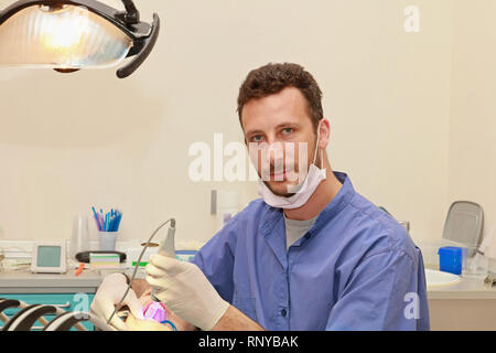Bello il medico e il paziente in studio dentistico Foto Stock