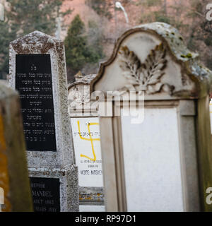 Soggetto ad atti vandalici tombe in con simboli nazisti in giallo spray-dipinte sulle tombe danneggiato - Cimitero Ebraico in Quatzenheim vicino a Strasbourg Foto Stock