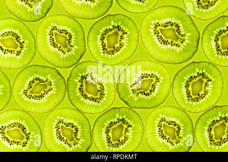 Fette di Kiwi illuminato dal basso frutti di sfondo vista superiore Foto Stock