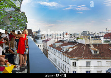 Due signore prendendo un selfie con la vista della città in background dal bar sul tetto di Lamée hotel a Vienna, in Austria Foto Stock