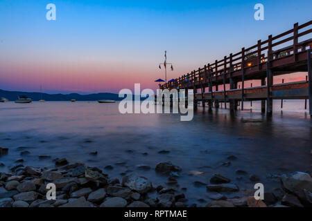 Corniola Bay, California USA - Luglio 18, 2015: vista panoramica sul Lago Tahoe al tramonto da un vecchio molo in legno a Gar boschi Lake Tahoe ristorante Foto Stock