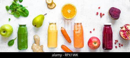 Vari frullati colorati o di succhi di frutta in bottiglie e ingredienti sul bianco. Una sana dieta vegana detox alimenti puliti concetto, vista dall'alto, banner. Foto Stock