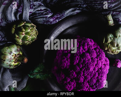 Edgy viola i cavolfiori e i carciofi fotografia scuro Foto Stock