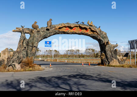 Zhangbei, Zhangjiakou, Hebei, Cina - 28 Settembre 2018: un segno che indica l'ingresso alla città. Arco di cemento oltre la strada asfaltata con uccello Foto Stock