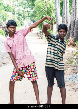 PUDUCHERY, INDIA - dicembre circa, 2018. Non identificato due adolescenti indiani asiatici due ragazzi guardando la fotocamera, facendo segno di vittoria con le dita, mostra Foto Stock