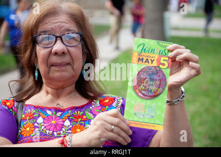 Donna ispanica di vendita pulsante annuale per sostenere il Cinco de Mayo parata e festeggiamenti. St Paul Minnesota MN USA Foto Stock