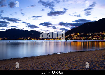 Romantico scenario di Locarno e il Lago Maggiore al crepuscolo Foto Stock