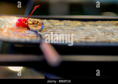 L'ultimo cherry su un gelato piatto per il miglior mangiare. Foto Stock