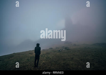 Uomo in piedi su foggy, etereo hill, Isola di Skye in Scozia Foto Stock