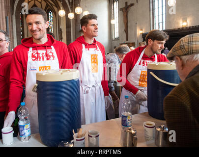 Stuttgart, Germania. 26 Febbraio, 2019. Christian Gentner (l-r), Mario Gomez, giocatore del VfB Stuttgart, nonché di Stoccarda del co-trainer Wolfgang del beller distribuire bevande ai visitatori in Vesperkirche. Gli atleti e i funzionari del VfB Stuttgart distribuiti pasti caldi e bevande ai bisognosi in un giorno intero di campagna. Credito: Sebastian Gollnow/dpa/Alamy Live News Foto Stock