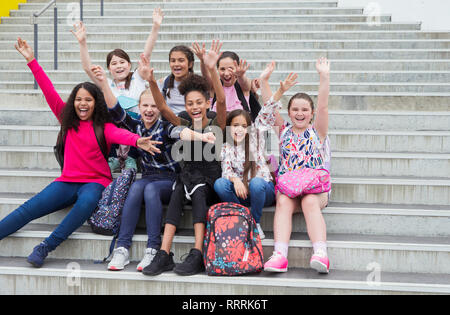 Ritratto entusiastico junior ragazza alta ondulazione gli studenti sulle operazioni Foto Stock