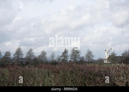 Immagine del paesaggio di campagna con le nuvole e il mulino a vento impostato nel Regno Unito Galles Foto Stock