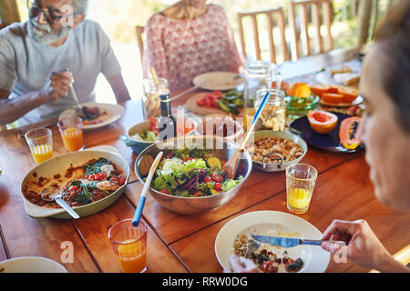 Amici mangiare sano pasto durante il ritiro di yoga Foto Stock