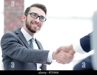 Due colleghi di lavoro che si stringono la mano durante la riunione. Foto Stock