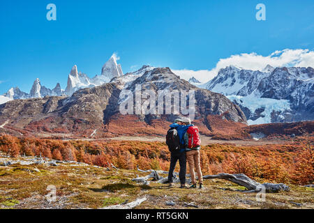 Argentina, Patagonia, El Chalten, giovane su un viaggio escursionistico kissing a Fitz Roy massiccio Foto Stock