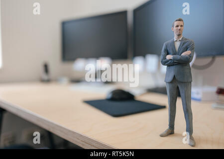 Imprenditore figurina in piedi sulla scrivania in ufficio moderno Foto Stock