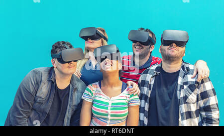 Multirazziale gruppo di amici a giocare giochi di realtà virtuale su occhiali vr indoor Foto Stock