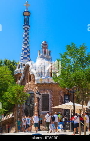 Barcellona, Spagna - Agosto 26, 2014: i turisti a piedi vicino all'edificio con la guglia all'entrata del Parco Guell di Barcellona Foto Stock