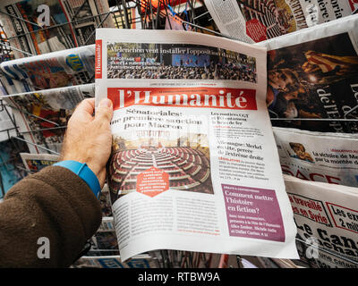 Parigi, Francia - Set 25, 2017: uomo Acquisto giornale più recente con il ritratto di Angela Merkel dopo elezioni in Germania per il cancelliere della Germania, il capo del governo federale Foto Stock