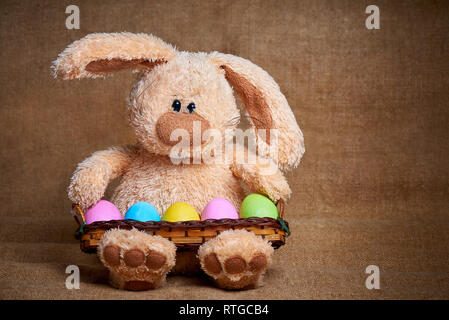 Morbide ripiene coniglio con luminosi colorati dipinti uova. Foto Stock