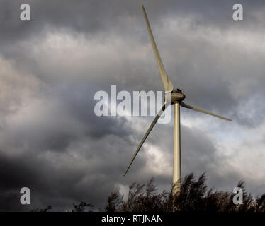 Un solitario turbina eolica a Middleton Top nel Derbyshire Peak District rivolta verso il profilarsi nuvole scure Foto Stock