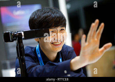 Un Letinarr membro dello staff alla prova la loro ottica di AR augmented reality sistema ottico interno Letinar stand al Mobile World Congress di Barcellona, Spagna, Foto Stock