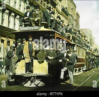 Foto colorata di una funivia sovraccaricata (la tratta 'Oakwoods - 71st Street') mentre i passeggeri si affollano all'esterno e sul tetto durante un giro in Chicago Day, Chicago, Illinois, 9 ottobre 1893. Il Chicago Day faceva parte dell'esposizione colombiana del mondo (conosciuta anche come la fiera del mondo di Chicago). (Foto di Burton Holmes) Foto Stock