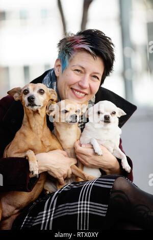 Donna con i suoi tre cani sul suo giro, un Pinscher in miniatura e due Chiuhahuas, Nord Reno-Westfalia, Germania Foto Stock