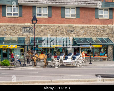 Banff Avenue negozi e turisti su Giugno 19, 2015 nel Parco Nazionale di Banff, Alberta, Canada. Banff Avenue è il quartiere centrale dello shopping in città o Foto Stock