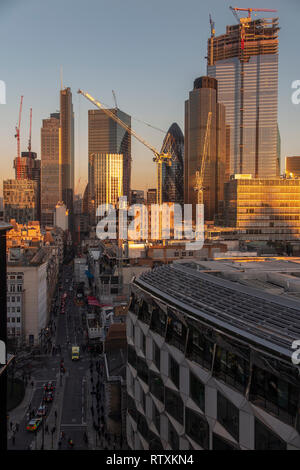 Un drammatico City of London skyline con gli alti edifici immersi nella luce dorata Foto Stock