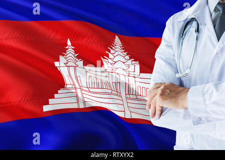 Medico cambogiano in piedi con uno stetoscopio sulla Cambogia bandiera dello sfondo. Sistema sanitario nazionale concetto, tema medico. Foto Stock