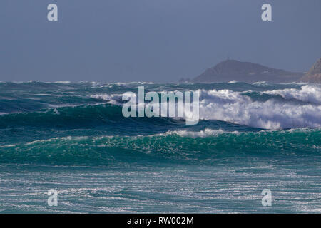 Sennen, Cornwall, Regno Unito. Il 3° marzo 2019. Gale force venti e 20ft di onde alte ancorare le scogliere di granito della Cornovaglia. Ponticelli audaci ottenere catturati da alcune enormi ondate di subissare la pier. Credito: Mike Newman/Alamy Live News. Foto Stock