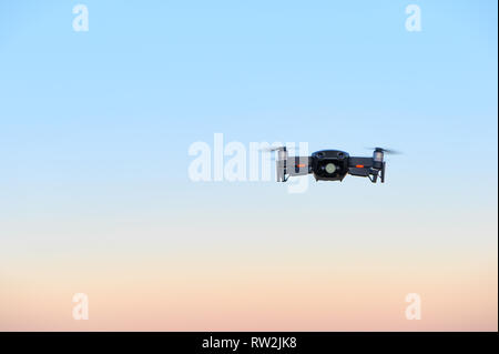 Piccolo drone nella parte anteriore del magico tramonto Cielo Foto Stock