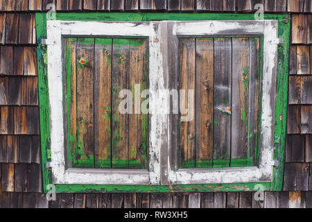 Vecchie persiane in legno del legno di un rifugio alpino con colori sfaldato Foto Stock