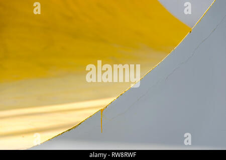 Colorato (giallo, grigio, bianco) parete dipinta con crepe. Abstract sfondo colorato con texture, mix di colore giallo e grigio, copre con design minimalista. Foto Stock