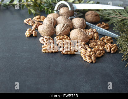 Noci su uno sfondo nero, gherigli di noce. Cibo sano da noce. Close-up. Foto Stock