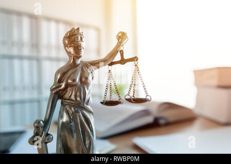 Signora giustizia statua in studio legale avvocato office, con gli occhi bendati Justitia con bilance di precisione e la spada è la personificazione della forza morale giudiziaria sist Foto Stock