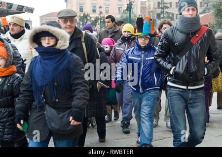 Gruppi di persone camminare durante il fine settimana di carnevale a Venezia, Italia indossando cappotti Foto Stock