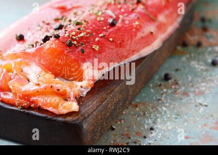 Gravlax, barbabietole scandinavo indurito salmone speziato sul bordo, vista dall'alto, salate pesce rosso Foto Stock