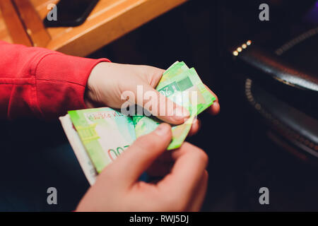 Gli uomini con le mani in mano contare il denaro russo close up Foto Stock