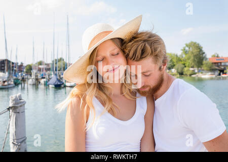 Romantico giovane coppia in barca a vela sul lago Chiemsee, Baviera, Germania Foto Stock