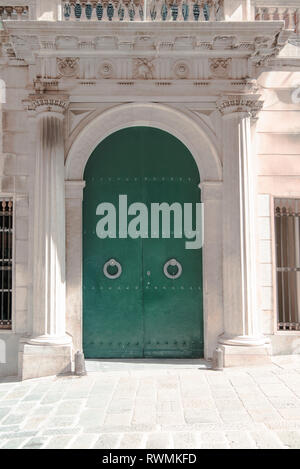 Porta di metallo color verde da un antico edificio italiano nel centro storico di Genova, Italia Foto Stock