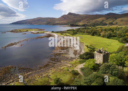 Vista aerea di Moy Castle in sera la luce solare con una Unione Jack bandiera e la montagna Beinn nan Gobhar dietro. Foto Stock