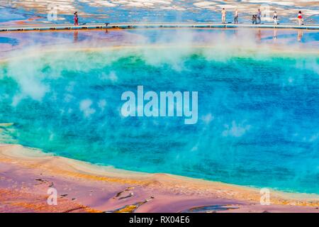 I turisti su un molo nella zona termale, cottura a vapore primavera calda, Grand Prismatic Spring, Midway Geyser Basin Foto Stock