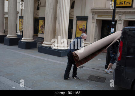 Montatori di tappeti portano fuori arrotolato moquette nuova nuovamente dopo la rifilatura per l interno del Lyceum Theatre sul Wellington Street, il 5 marzo 2019, a Londra, in Inghilterra. Foto Stock