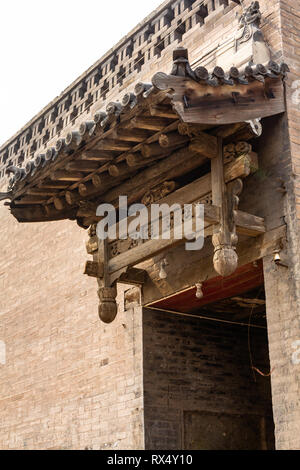 Uno dei tipici in legno decorazioni scolpite sopra le porte di entrata di Pingyao Città Antica, nella provincia di Shanxi, Cina. Di Pingyao è un patrimonio mondiale UNESCO Foto Stock