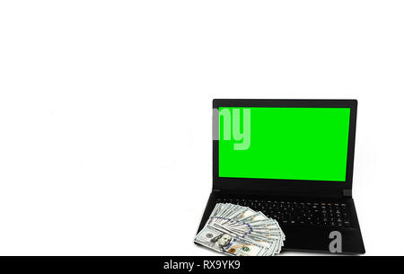 Inquadratura orizzontale di laptop o notebook con una diffusa del dollaro di denaro contante isolato su sfondo bianco con schermo verde modello di display mock up Foto Stock